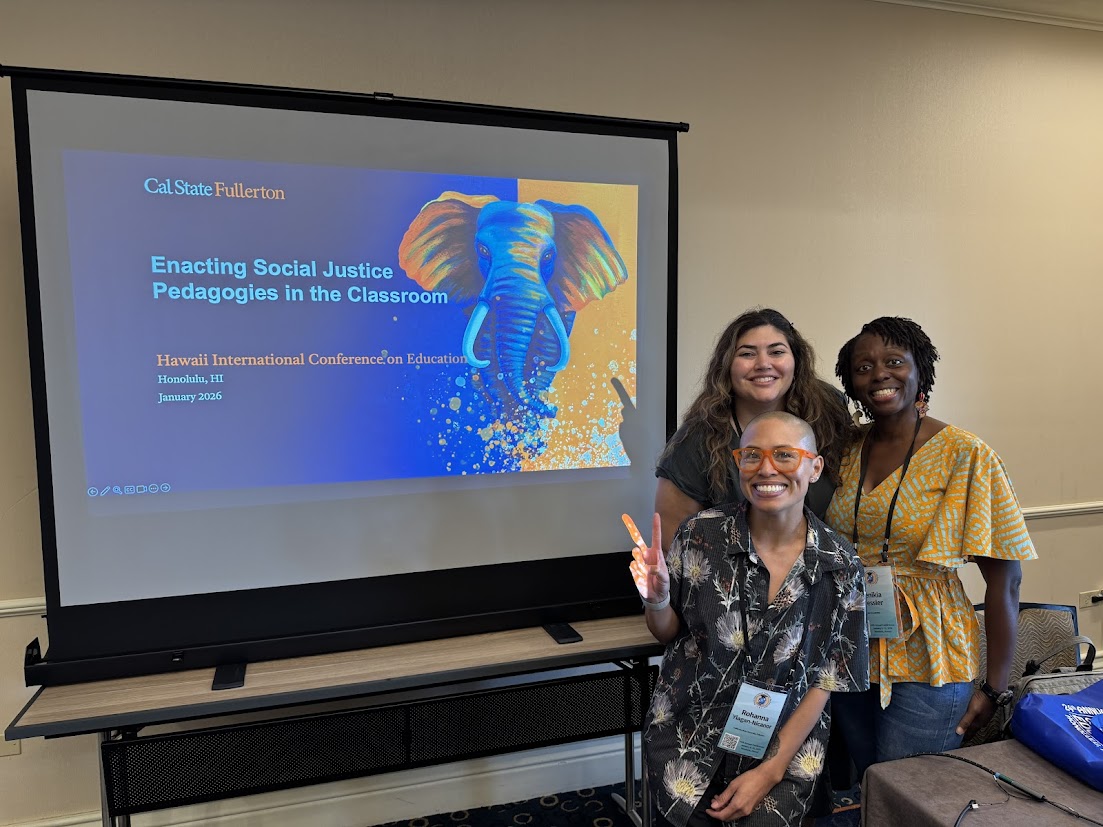 three people in front of a screen displaying a presentation